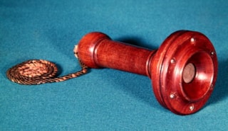 Alexander_Graham_Bell_-_Fourth_design_for_the_telephone_handpiece_1877_(wood)_-_(MeisterDrucke-588059)